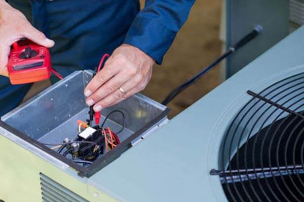 technician fixing heat pump